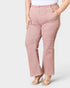 Pink pants worn by a person on a white background