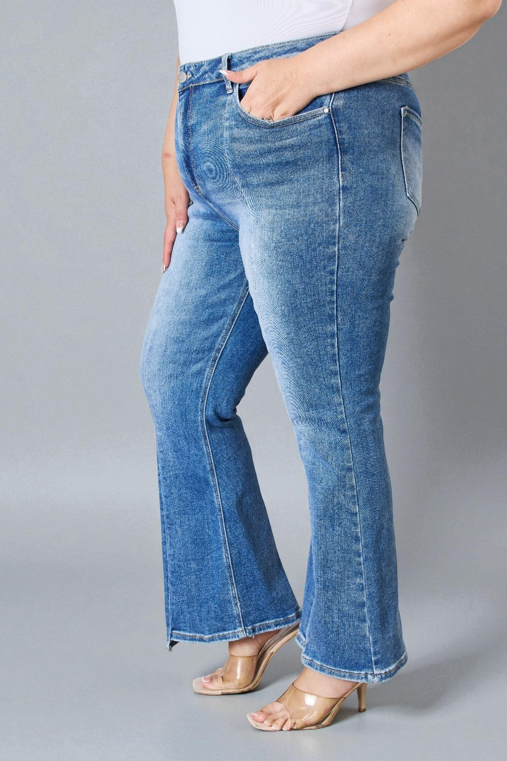 Person wearing blue jeans on a gray background