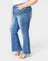 Person wearing blue jeans on a white background