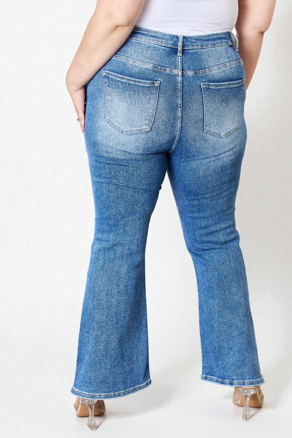 Blue jeans worn by a person on a white background