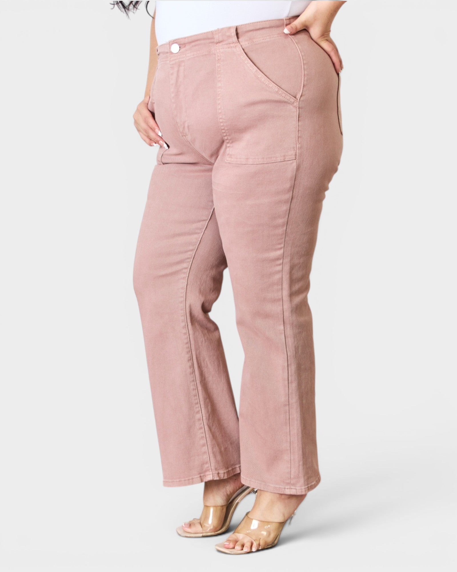 Pink pants worn by a person on a white background