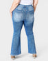 Person wearing blue flared jeans on a white background