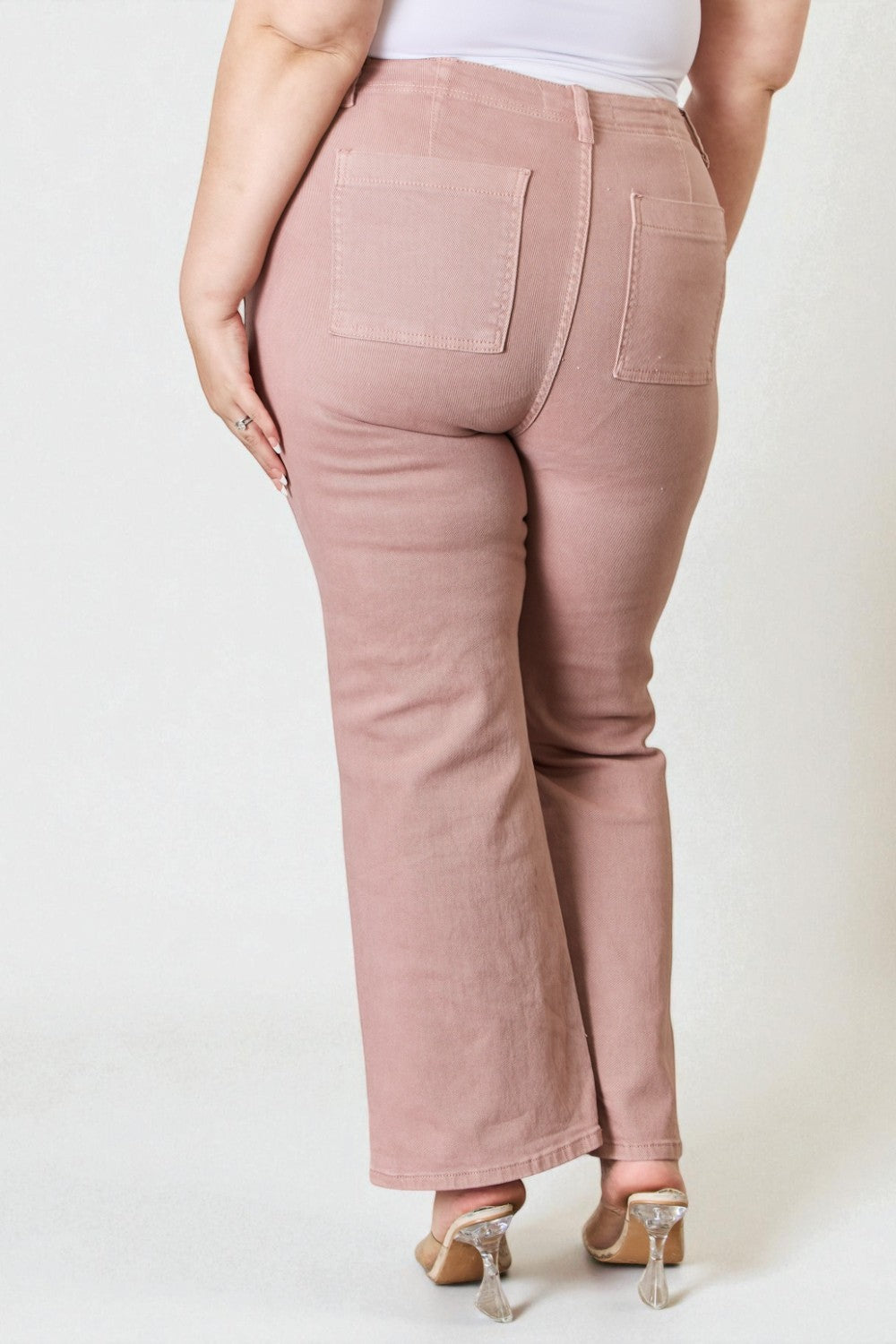 Pink pants worn by a person on a white background