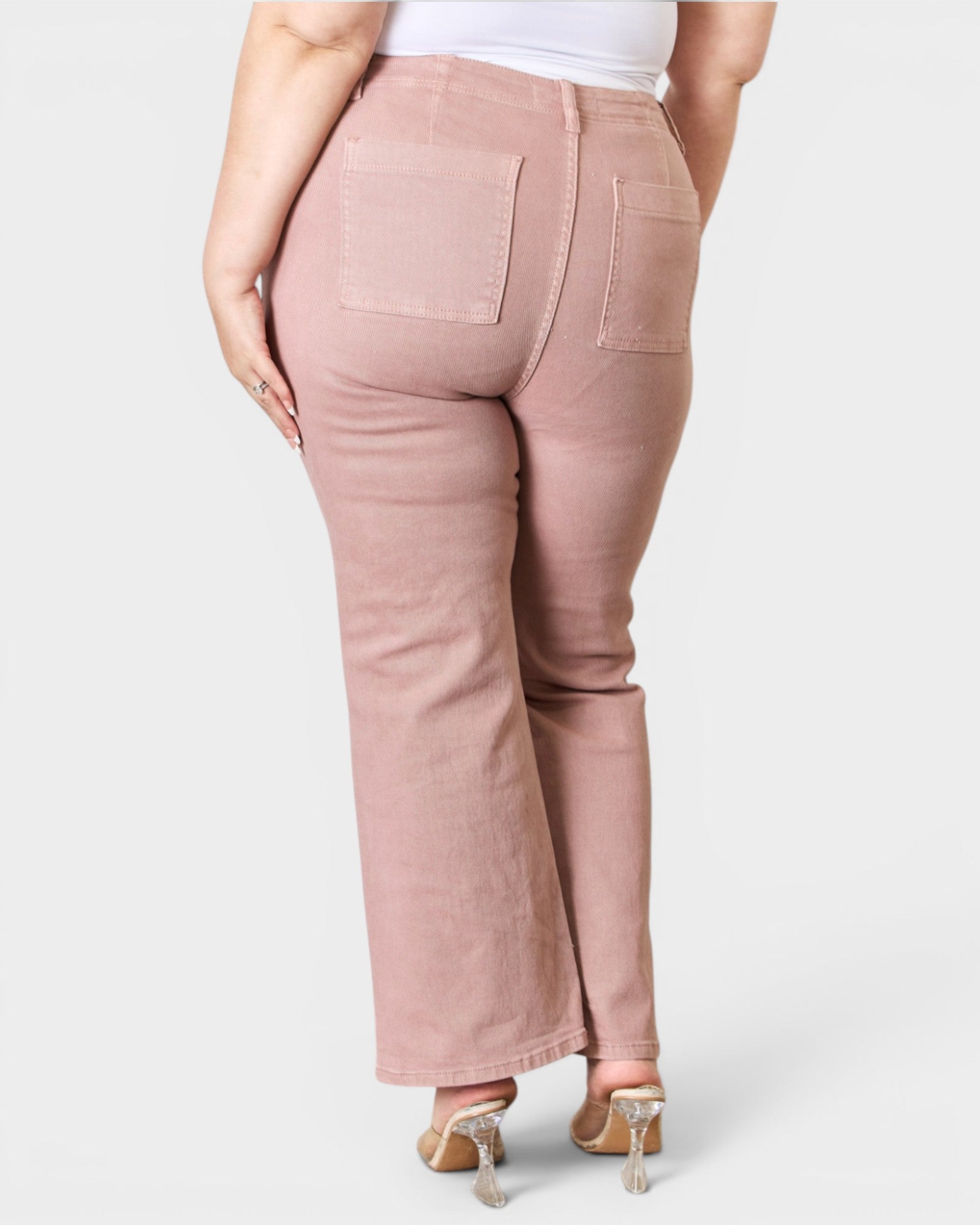 Pink pants worn by a person on a white background