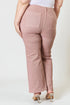 Pink pants worn by a person on a white background