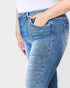 Blue jeans worn by a person on a white background