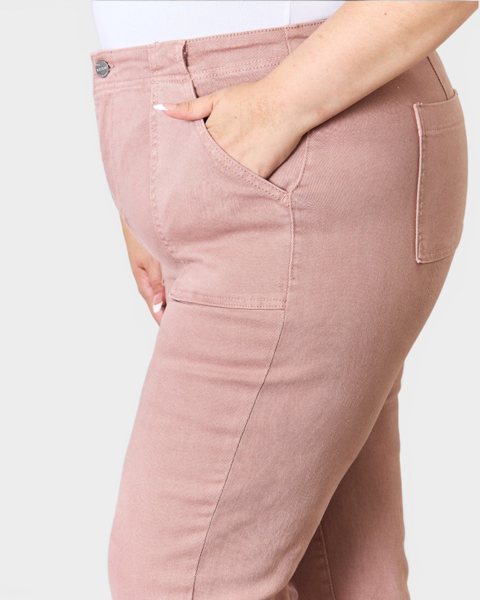 Pink pants worn by a person on a white background