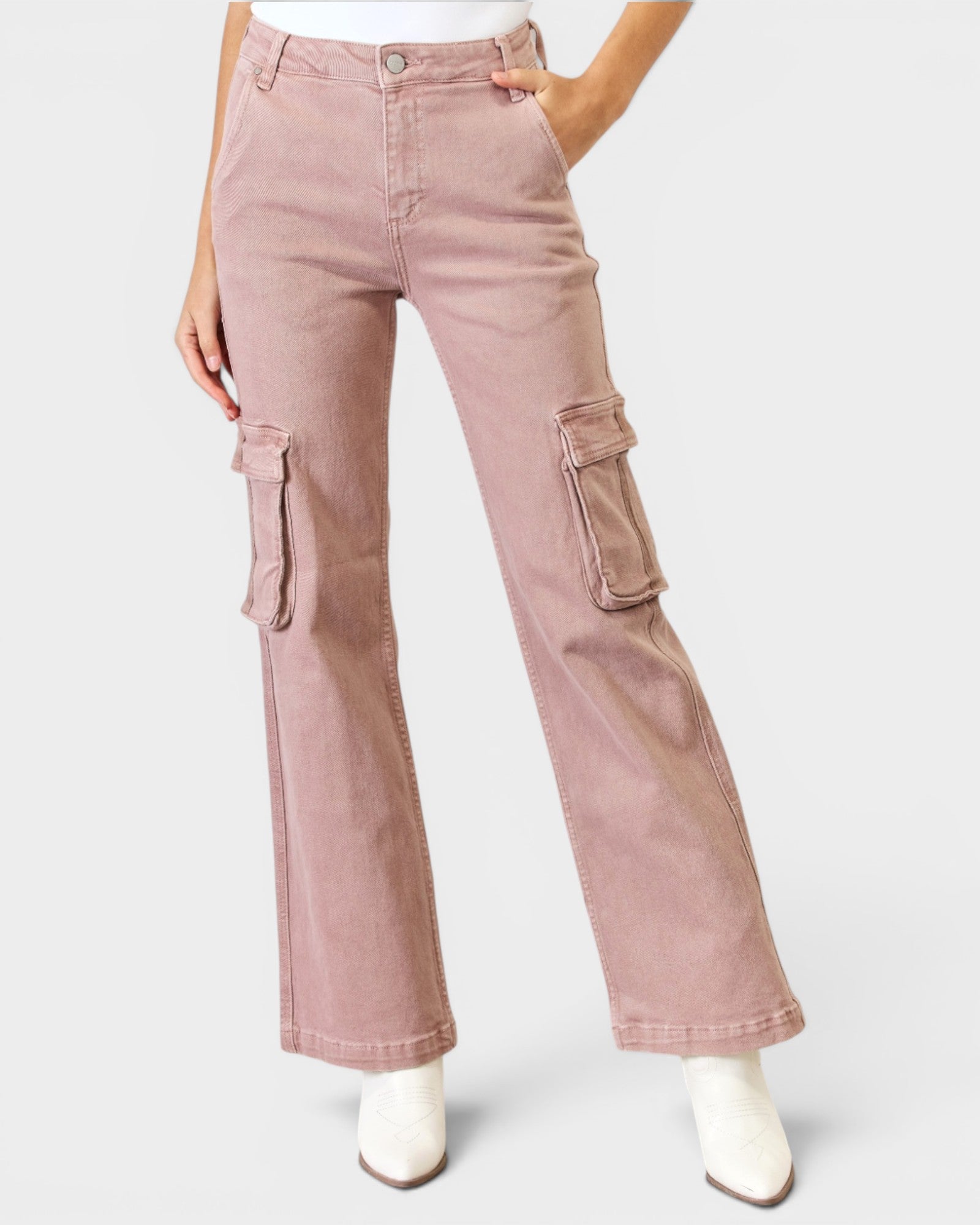 Pink cargo pants worn by a person on a white background