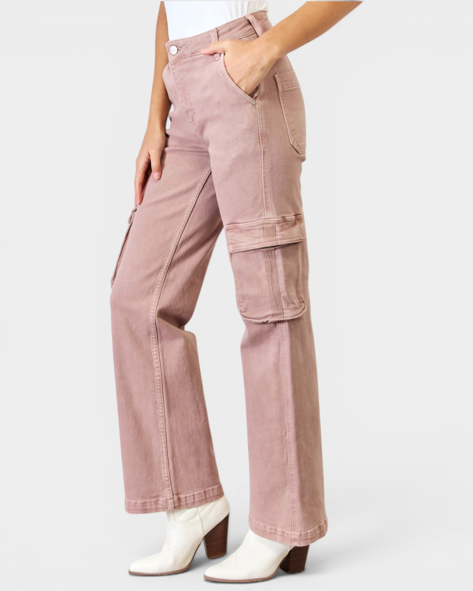 Pink cargo pants worn by a person on a white background