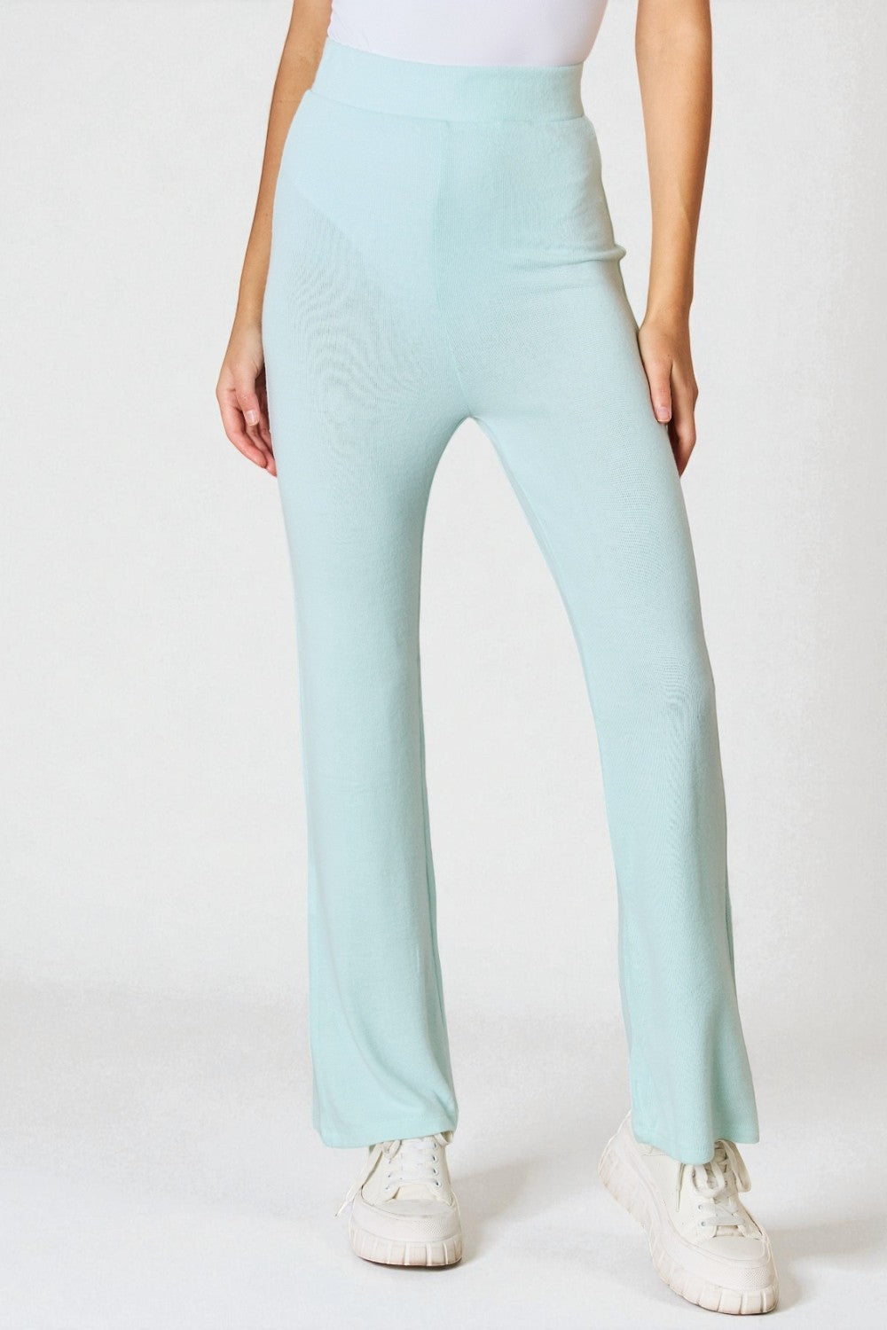 Light blue pants worn by a person on a white background