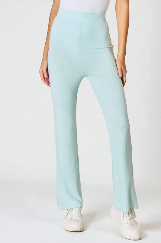 Light blue pants worn by a person on a white background