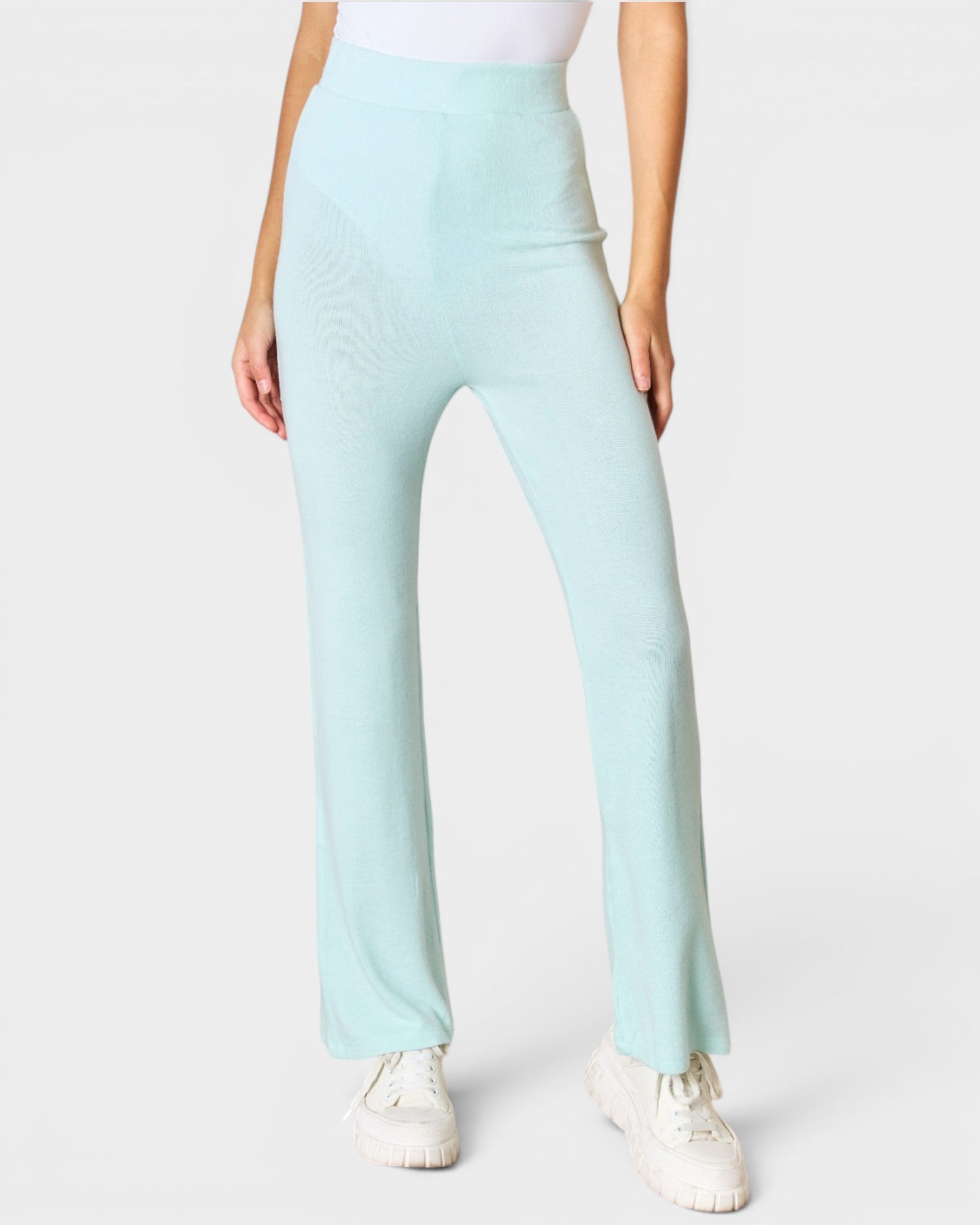 Light blue pants worn by a person on a white background