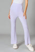 Person wearing light purple pants and white shoes on a gray background