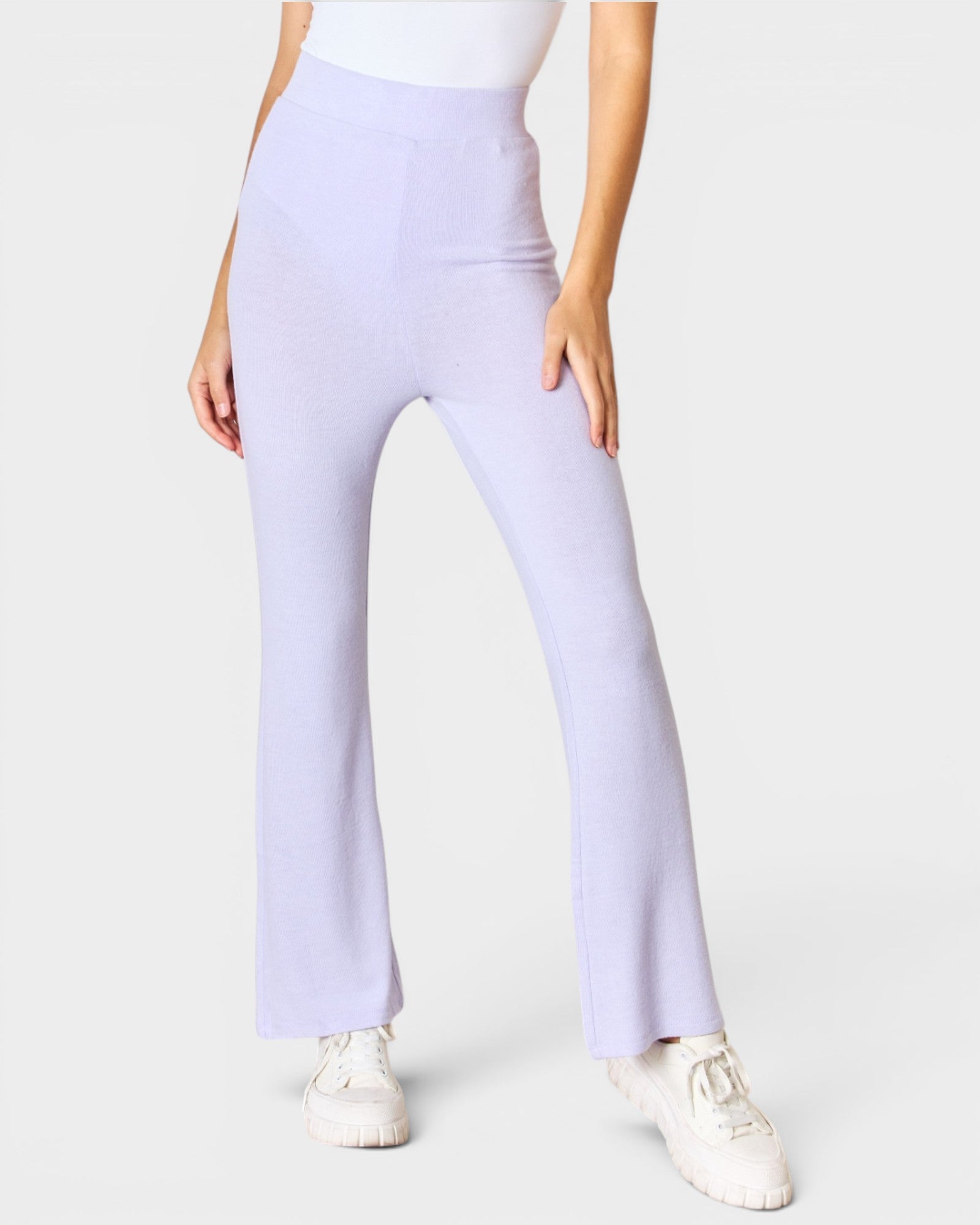 Person wearing light purple pants on a white background