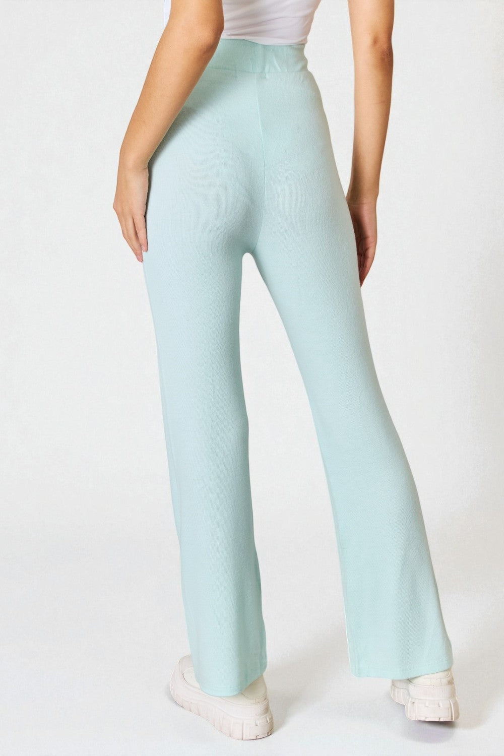Light blue pants worn by a person on a white background