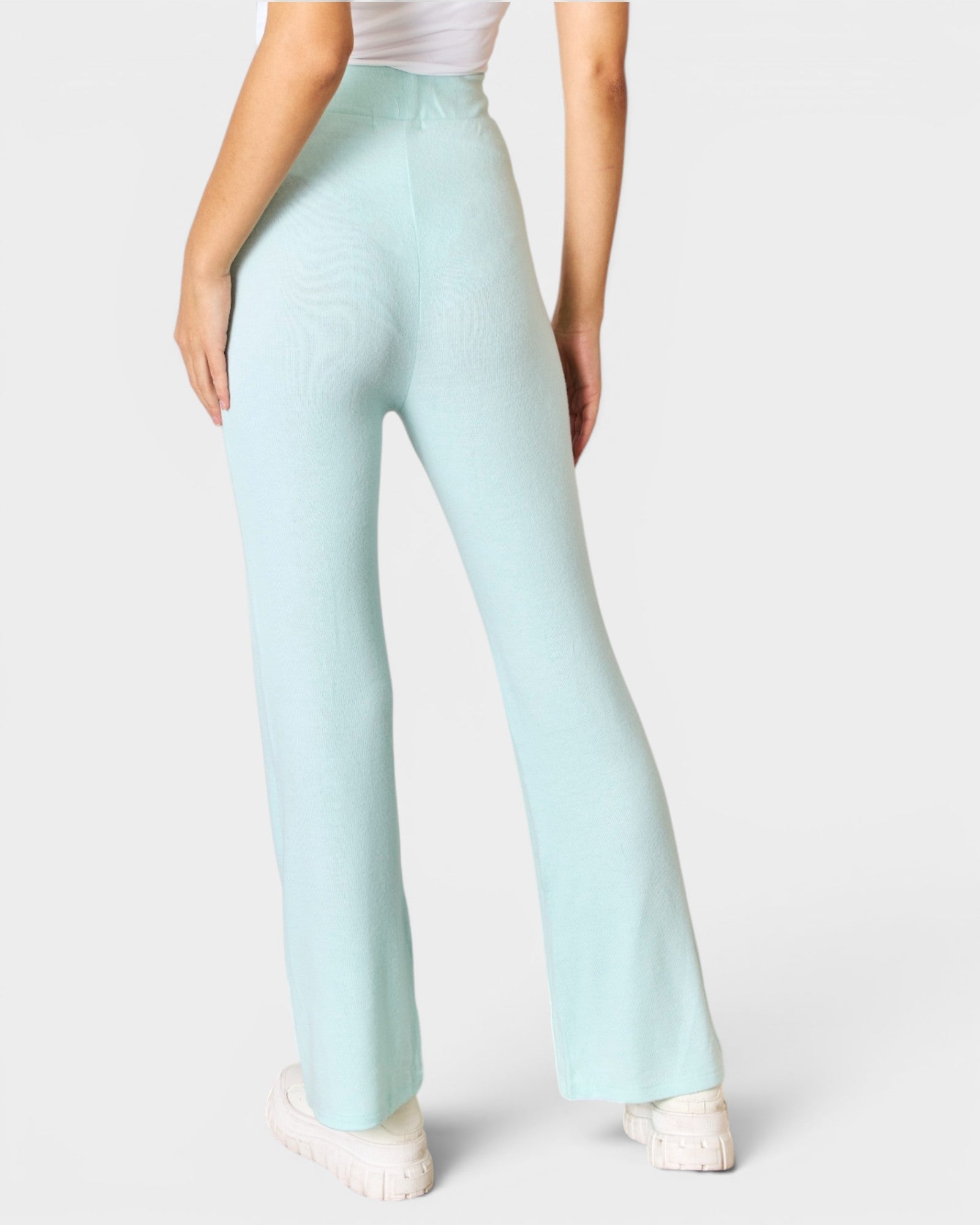 Light blue pants worn by a person on a white background