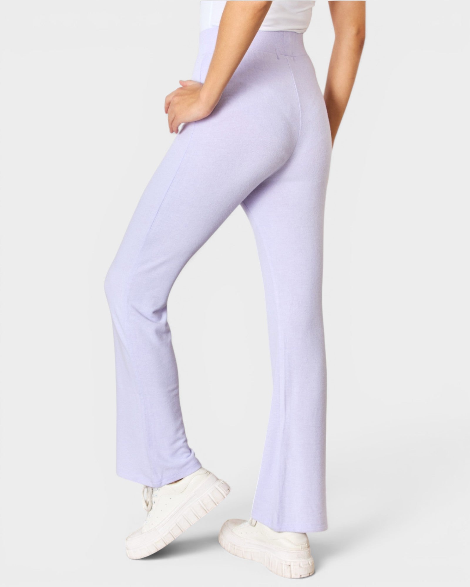 Person wearing lavender leggings on a white background