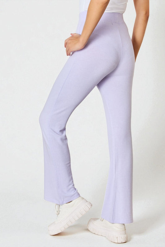 Person wearing light purple pants on a white background