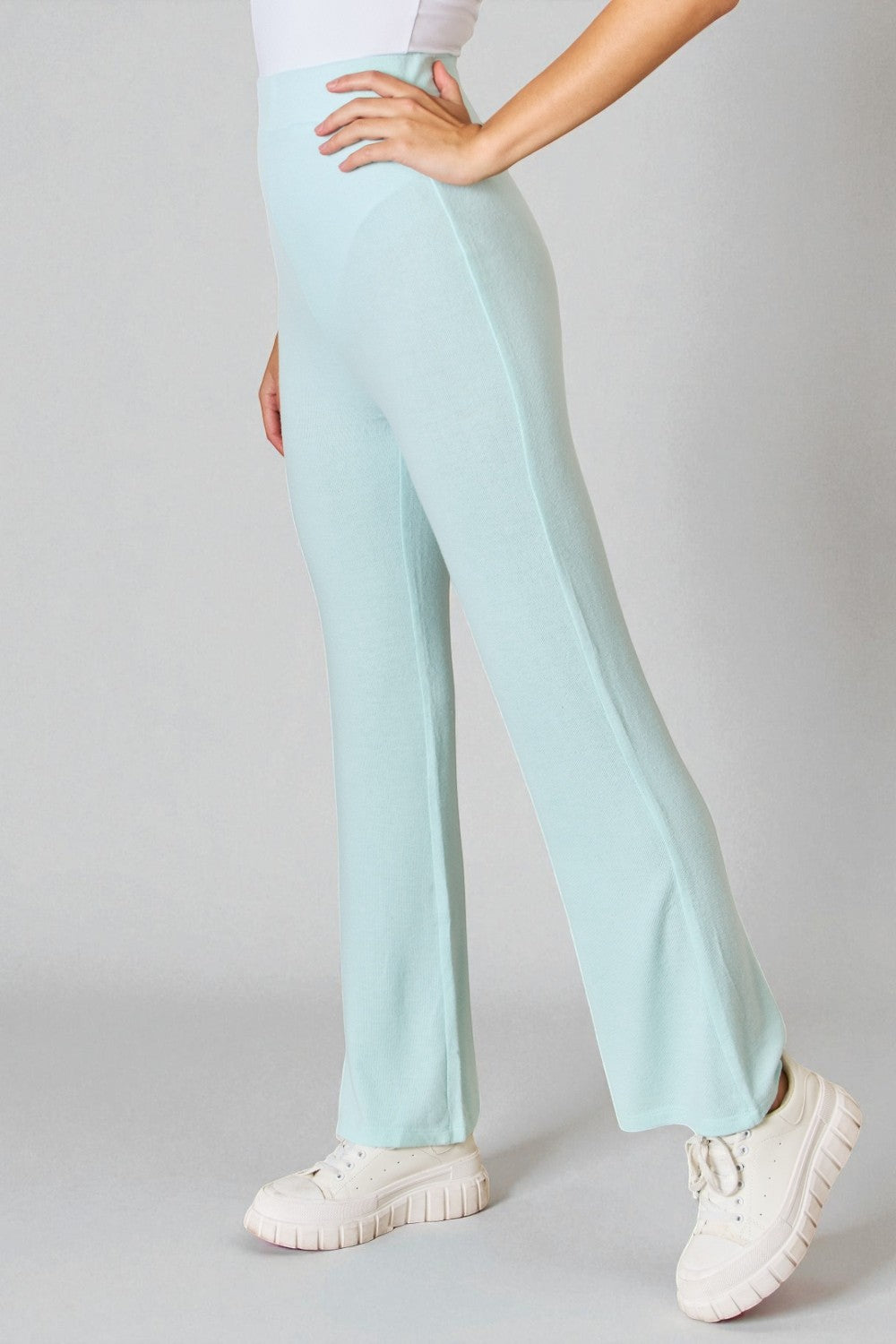 Light blue pants worn by a person on a gray background