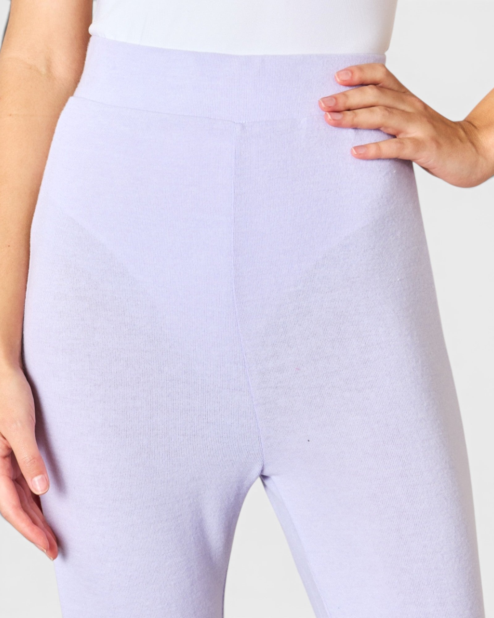 Lavender leggings worn by a person on a white background