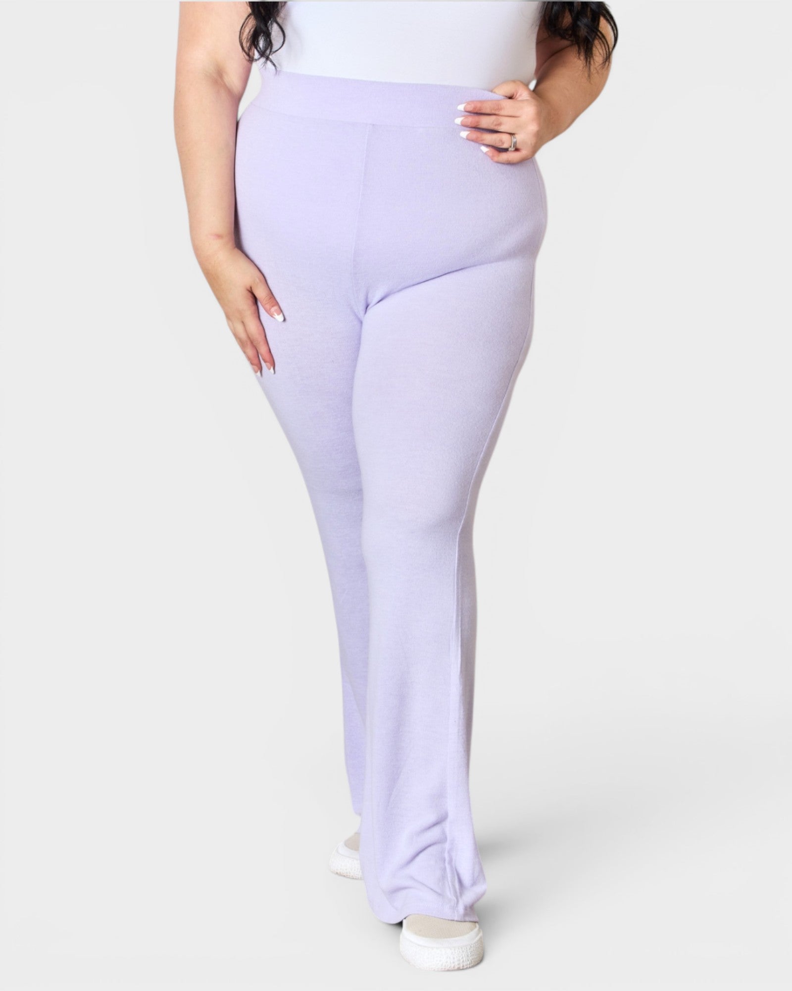 Person wearing lavender leggings on a white background