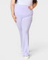 Person wearing lavender leggings on a white background