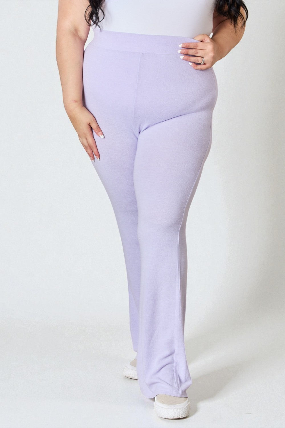 Person wearing light purple leggings on a white background