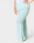 Light blue flared pants worn by a person on a white background