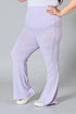 Person wearing light purple flared pants on a gray background