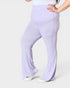 Person wearing light purple flared pants on a white background