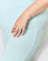 Close-up of a hand wearing a ring on a light blue fabric background