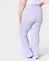 Lavender flared pants worn by a person on a white background