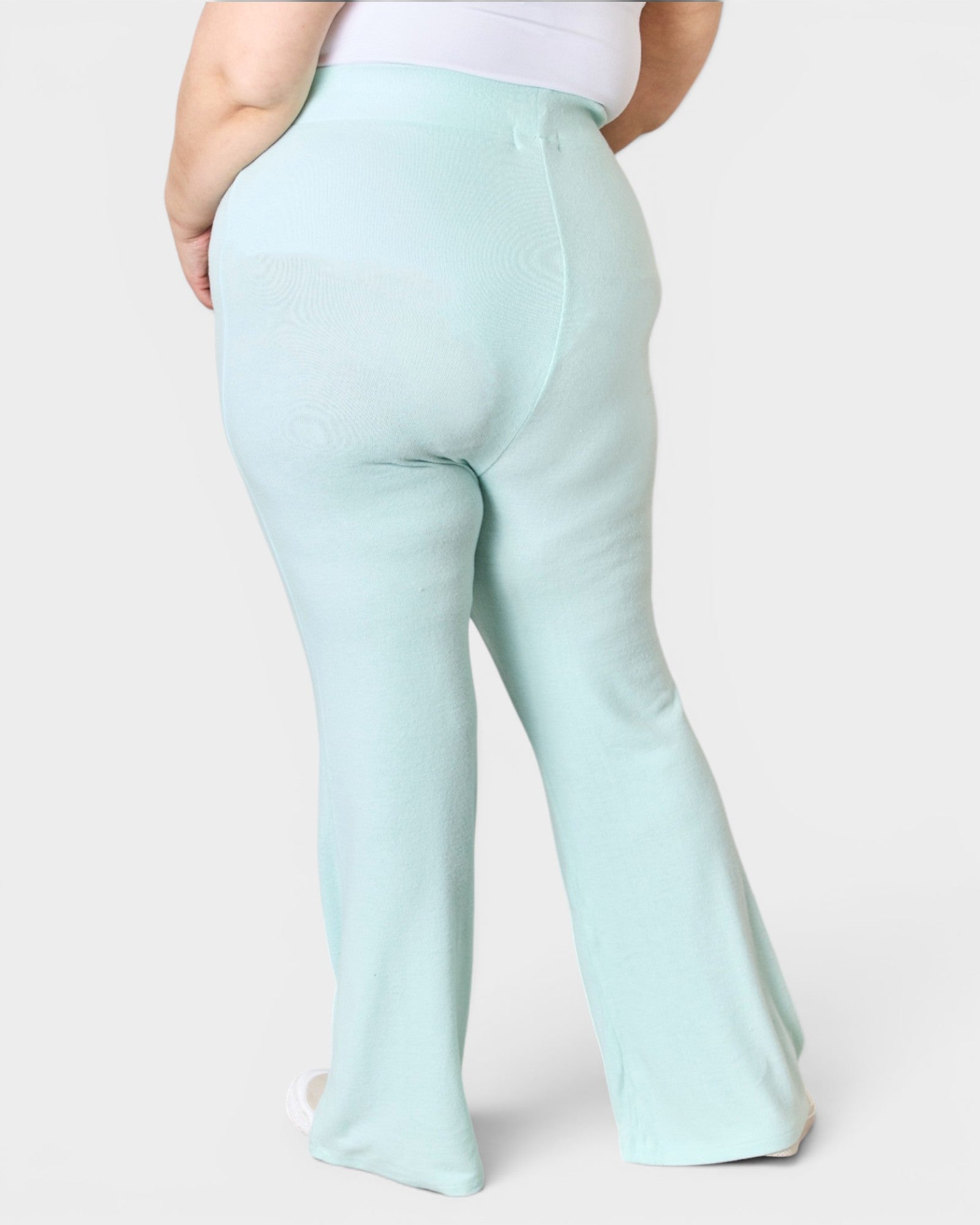 Light blue pants worn by a person on a white background