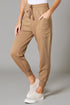 Tan jogger pants worn by a person on a gray background