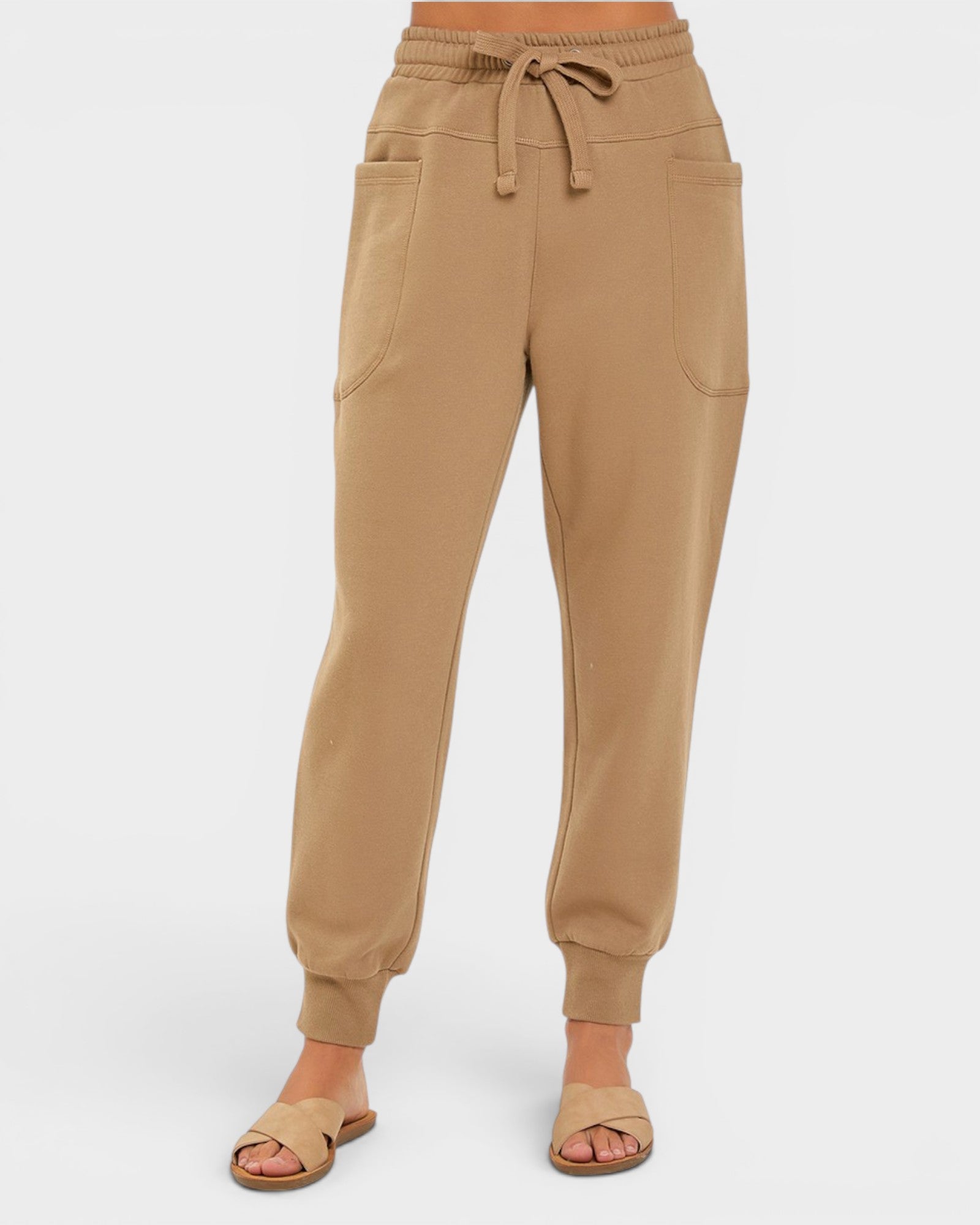 Tan jogger pants on a white background