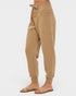 Tan jogger pants worn by a person on a white background