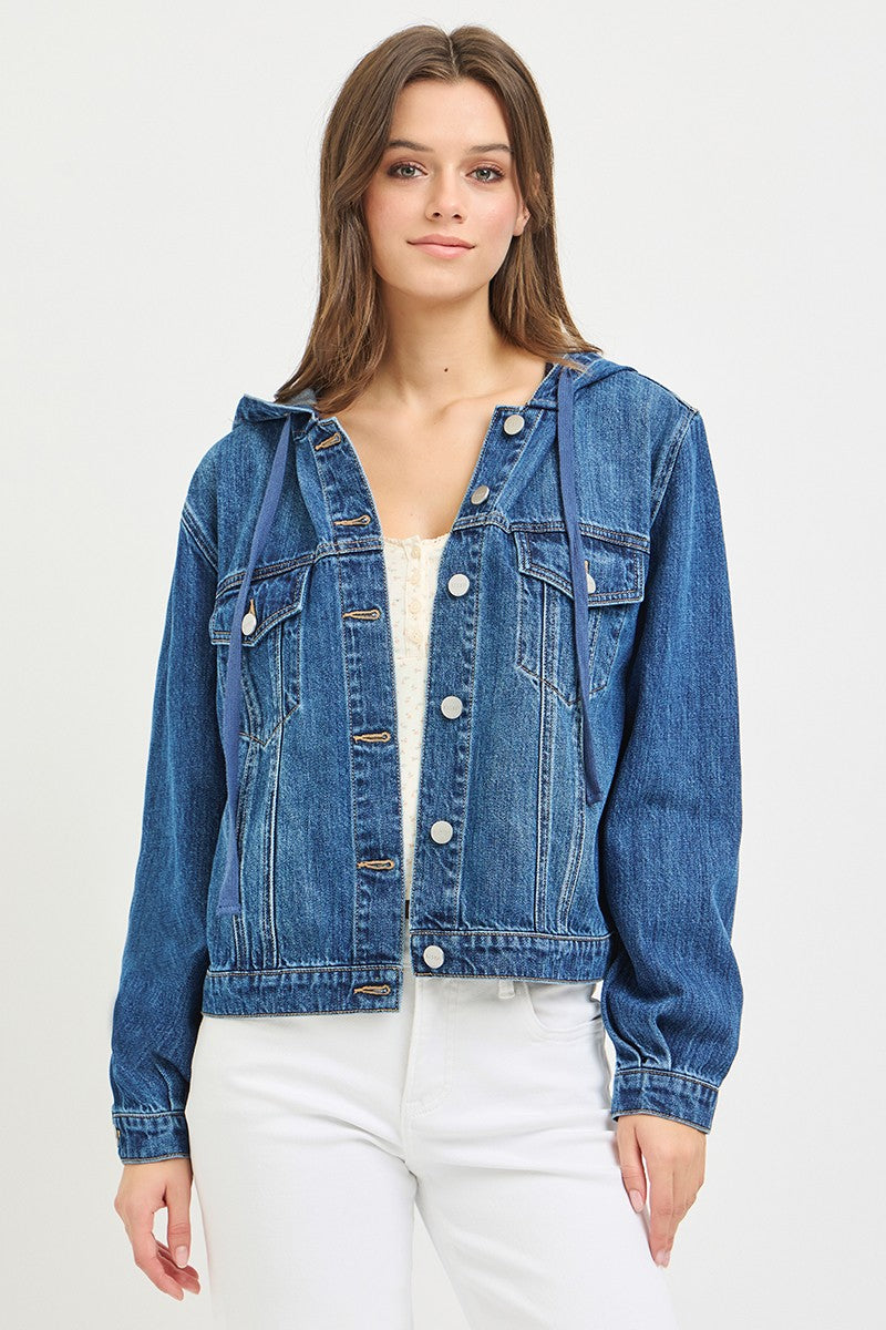 Woman wearing a blue denim jacket on a white background