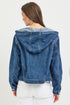 Blue denim jacket with a hood worn by a person on a white background