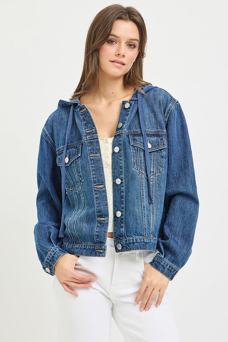 Woman wearing a blue denim jacket on a white background