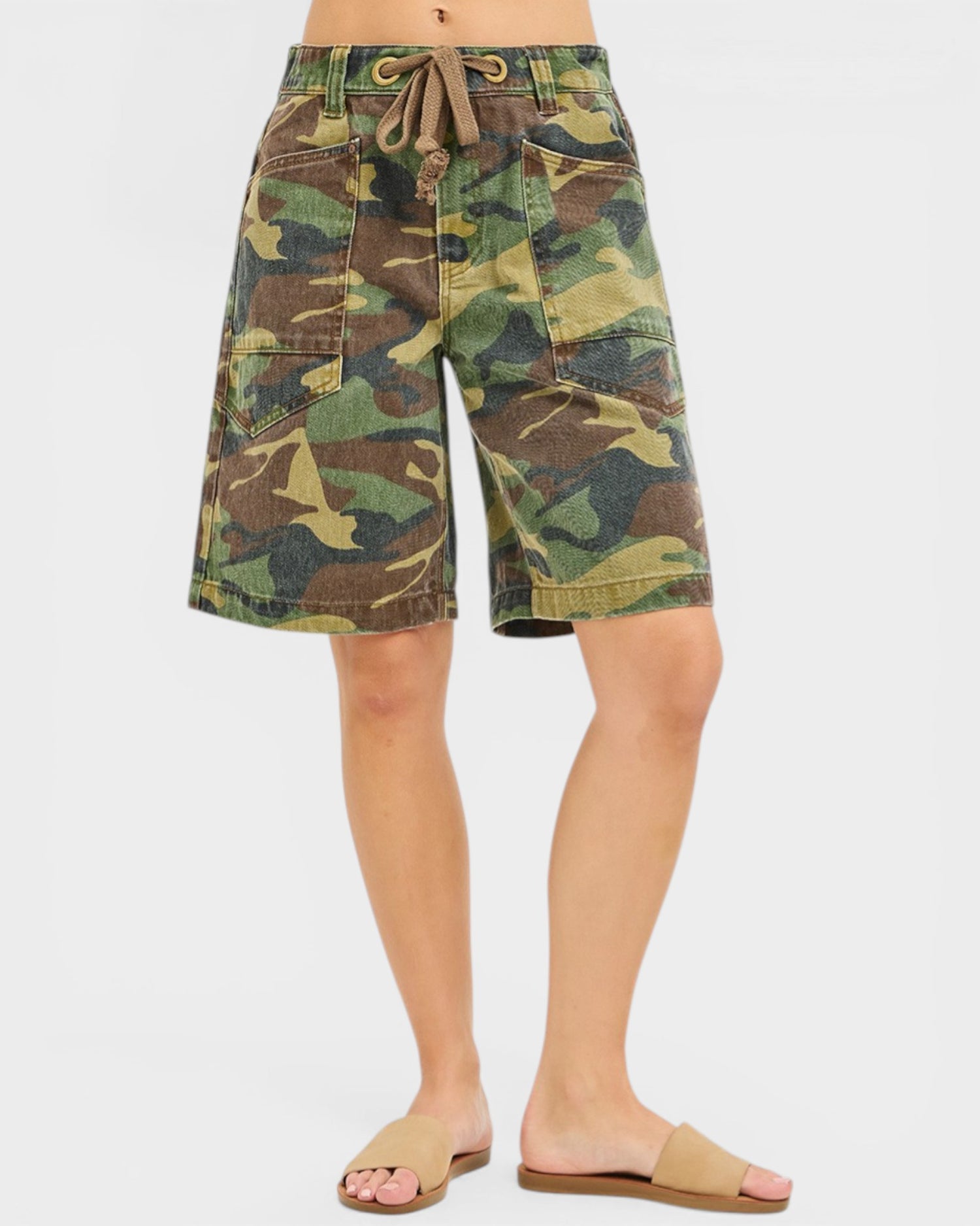Camouflage shorts worn by a person on a white background
