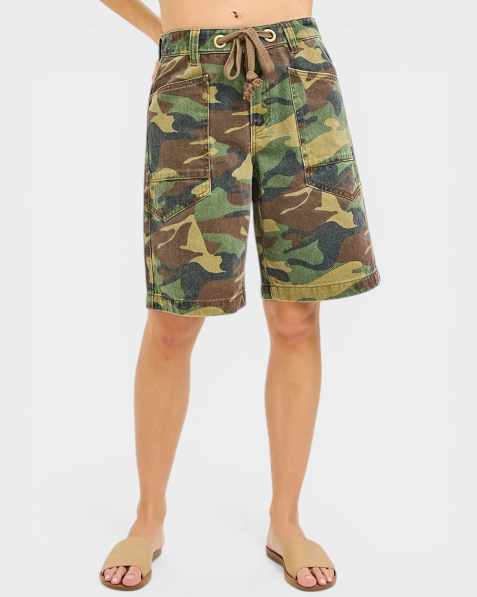 Camouflage shorts worn by a person on a white background