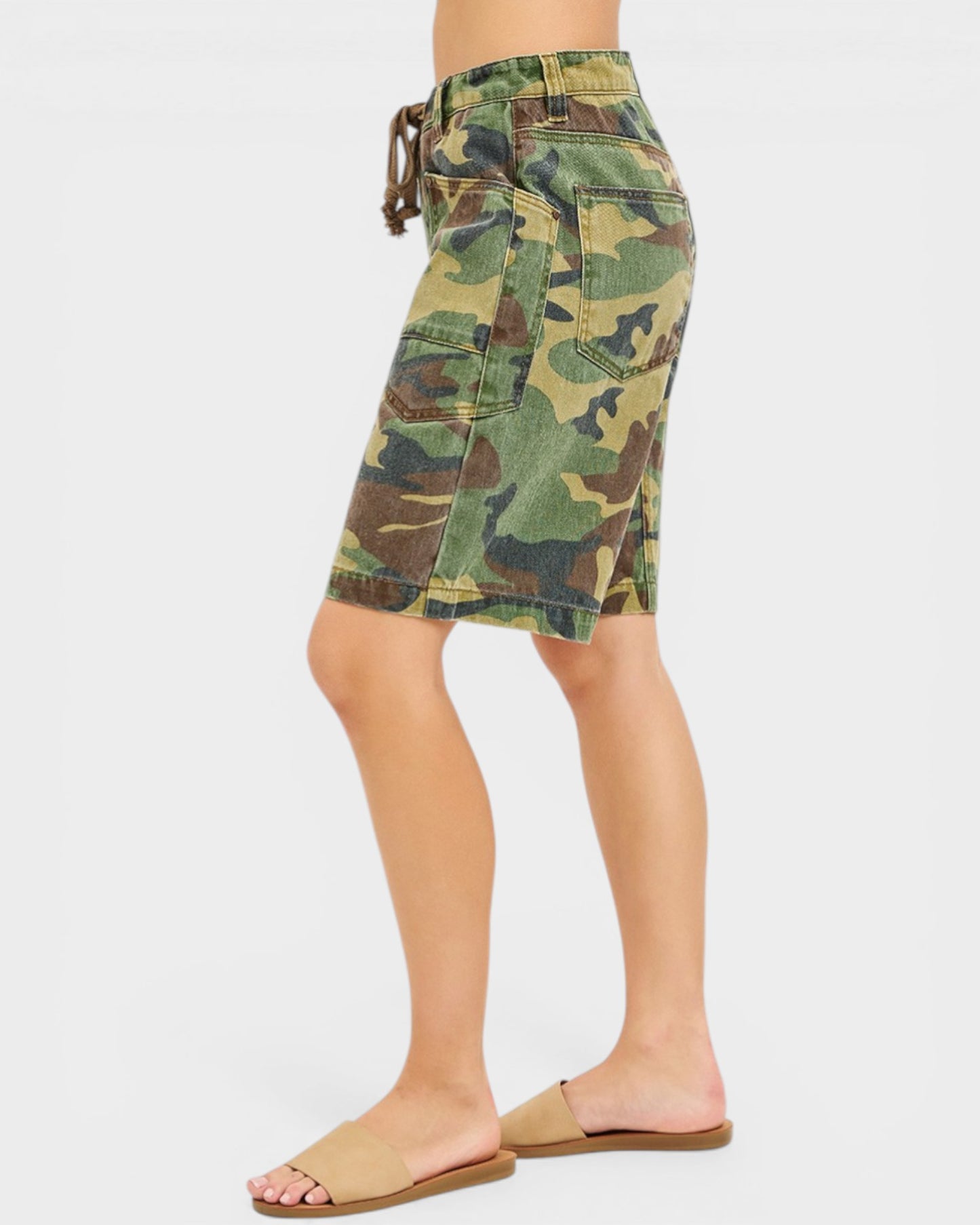 Camouflage shorts worn by a person on a white background