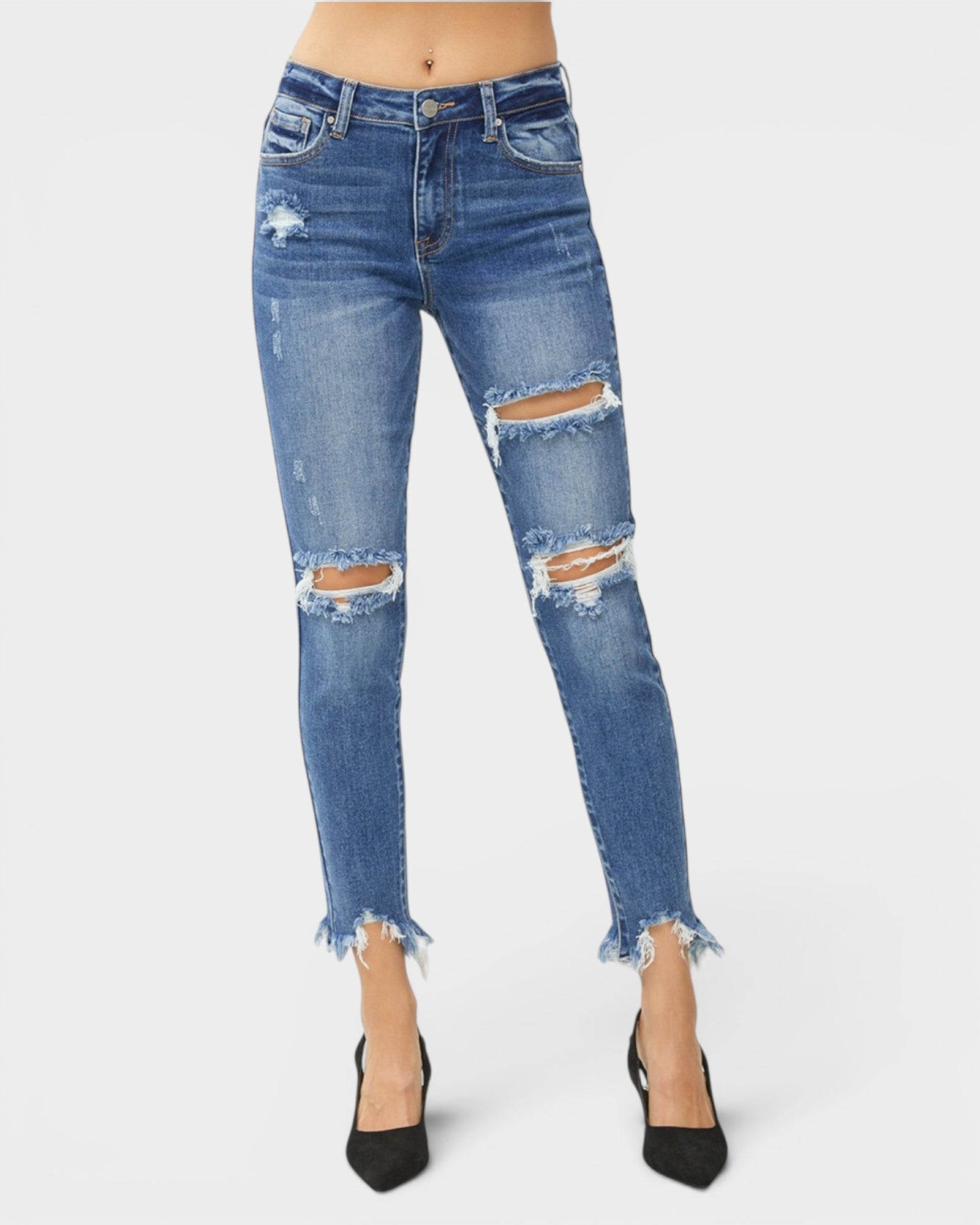 Ripped blue jeans worn by a person on a white background