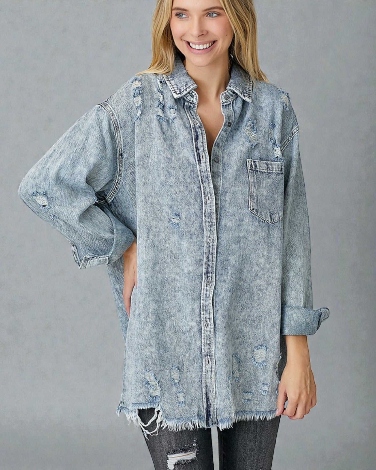 Woman wearing a light blue denim shirt with a gray background