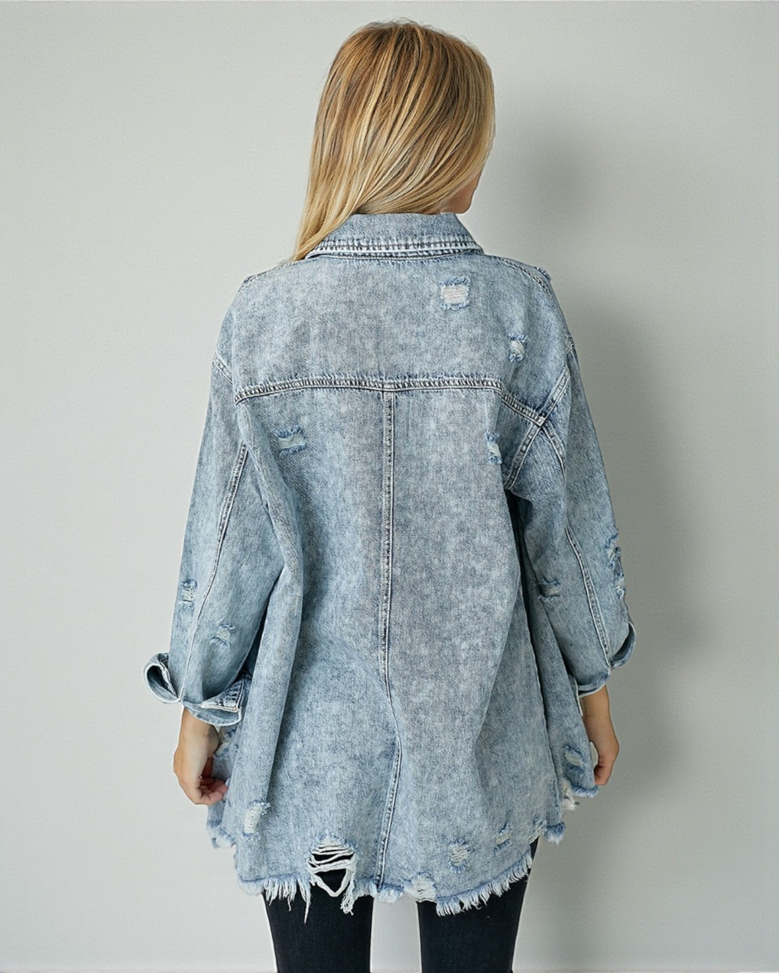 Light blue denim jacket worn by a person on a plain background