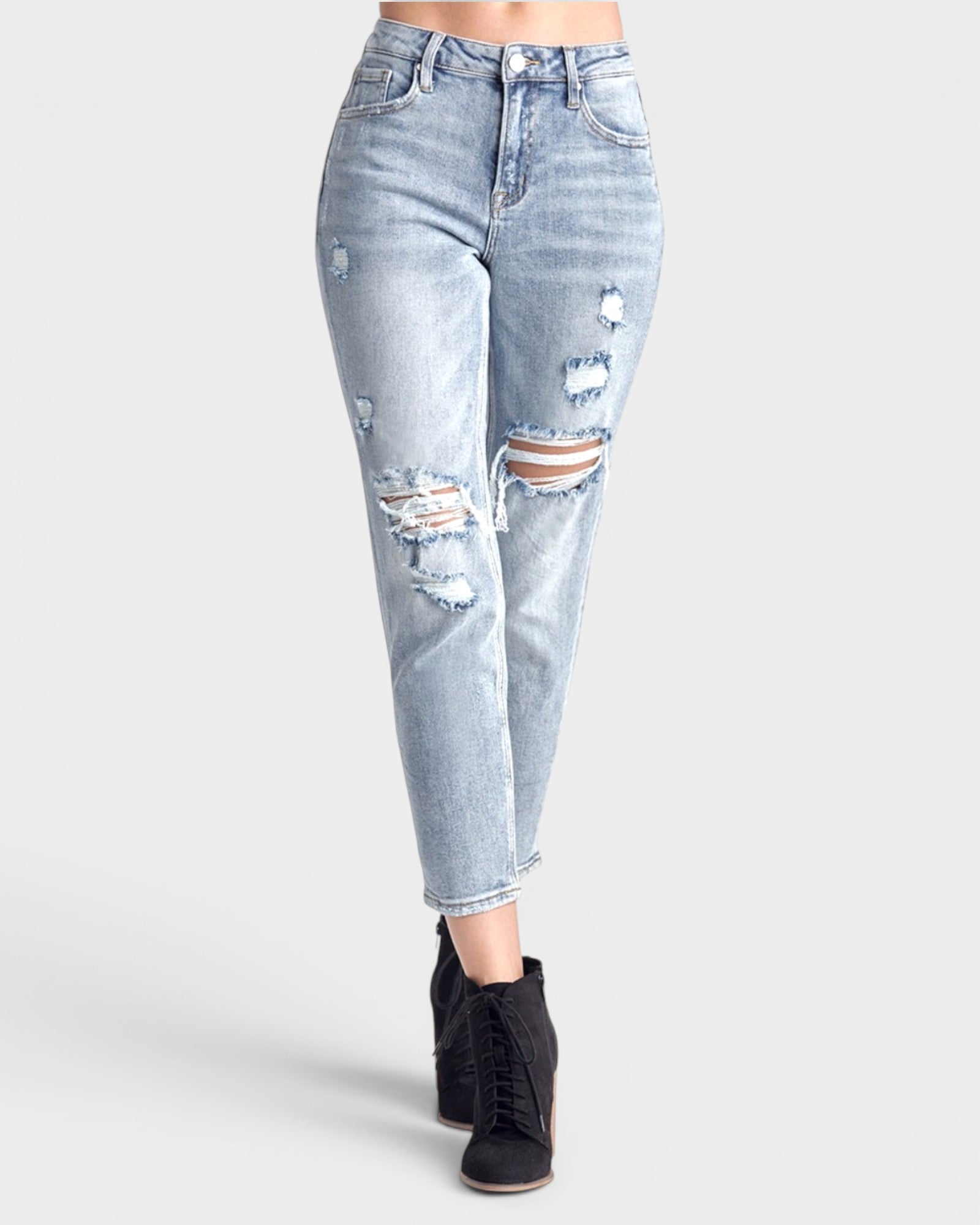 Light blue distressed jeans worn by a person on a white background