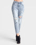 Light blue distressed jeans worn by a person on a white background