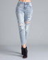 Light blue distressed jeans worn by a person on a gray background
