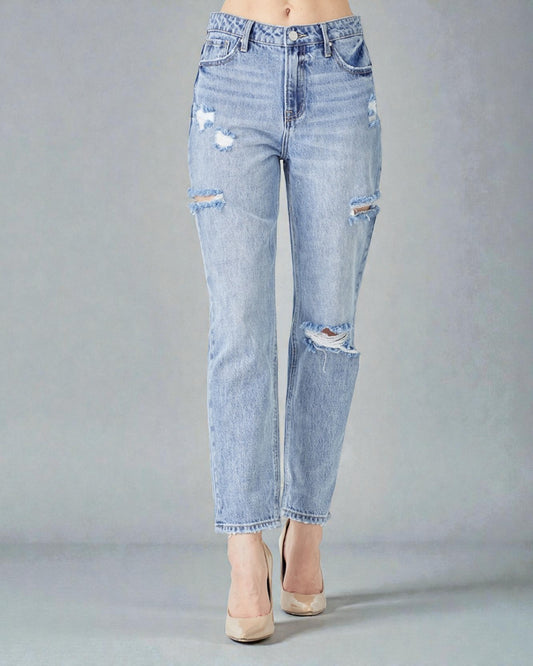 Light blue distressed jeans on a gray background