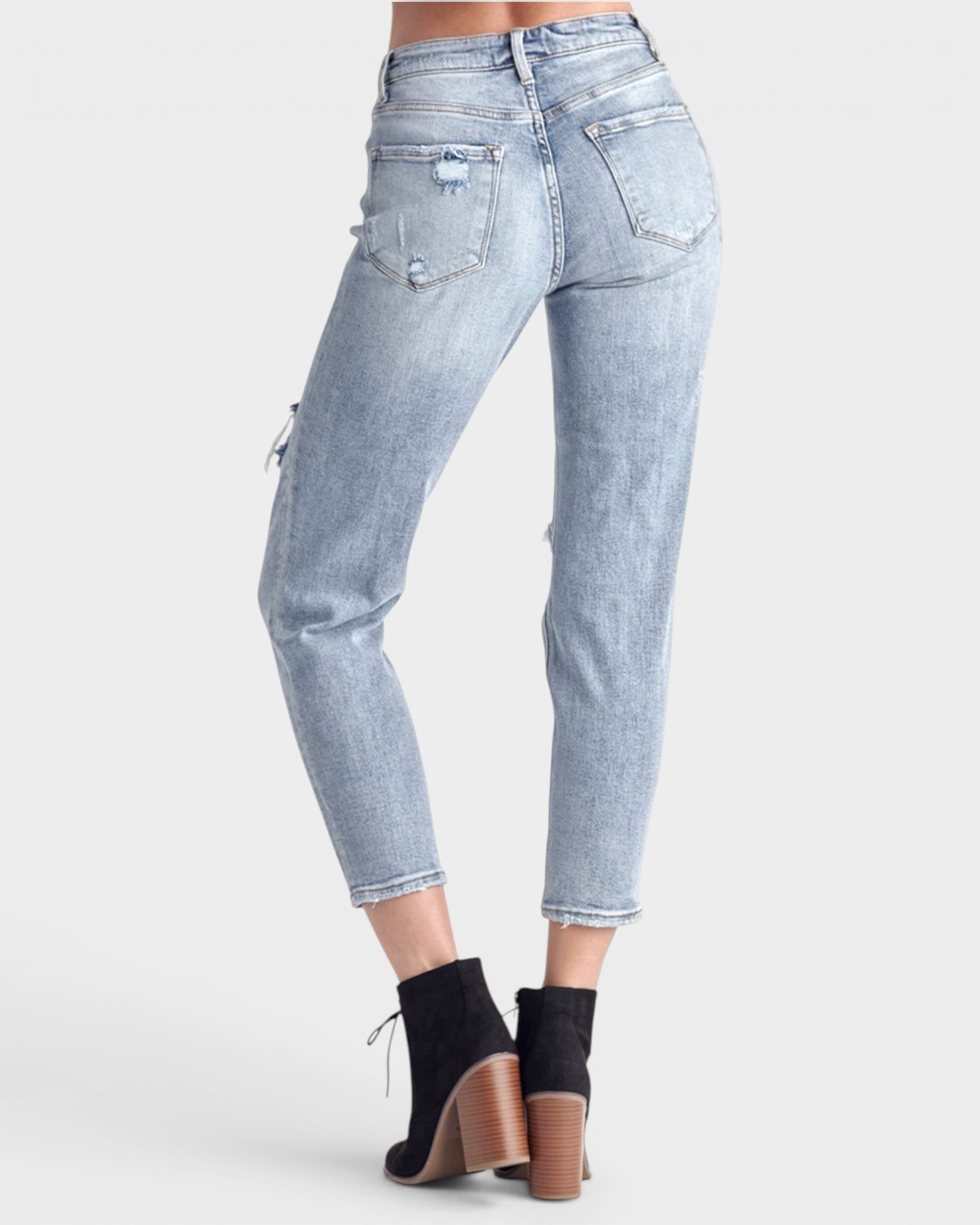 Light blue jeans worn by a person on a white background